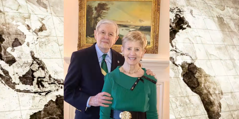 Charles and Nancy Bedford stand in front of a fireplace with a painting above the mantel.