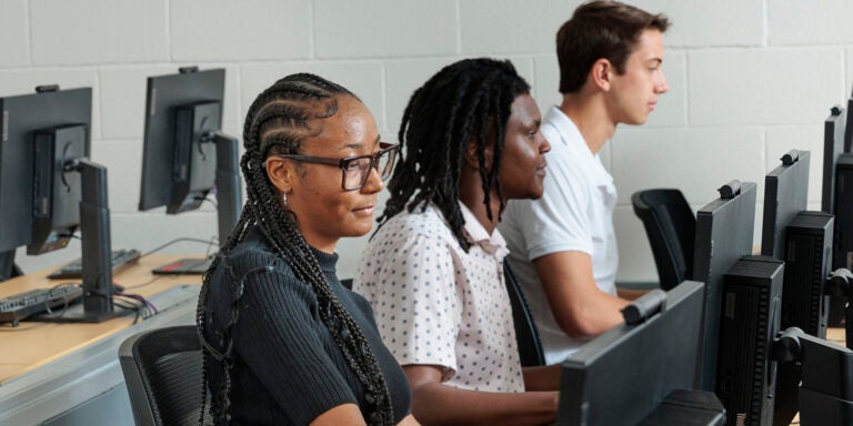 Three students working on computers